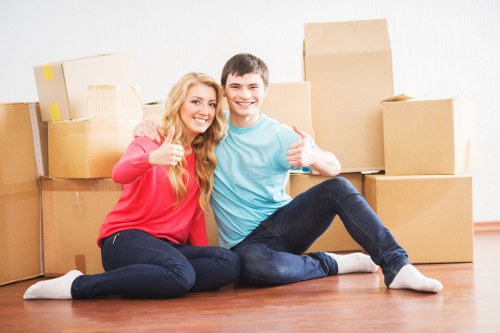 Office movers handling desks and IT equipment carefully